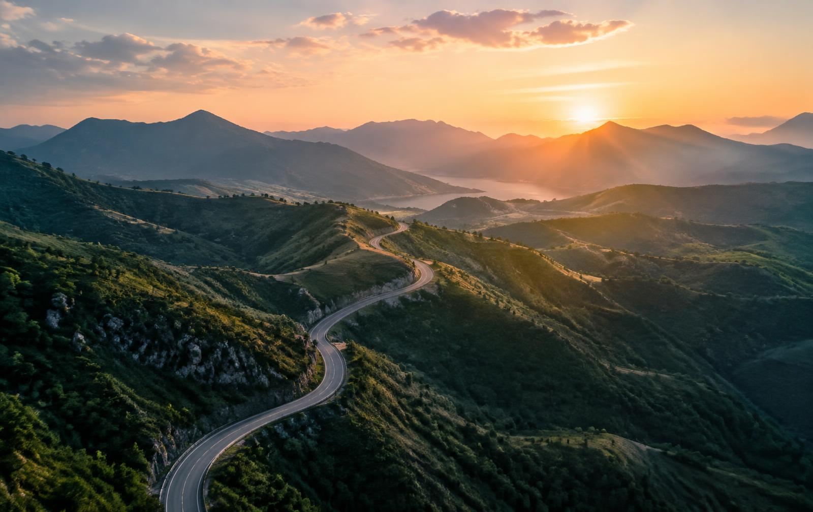 A winding mountain road at sunrise